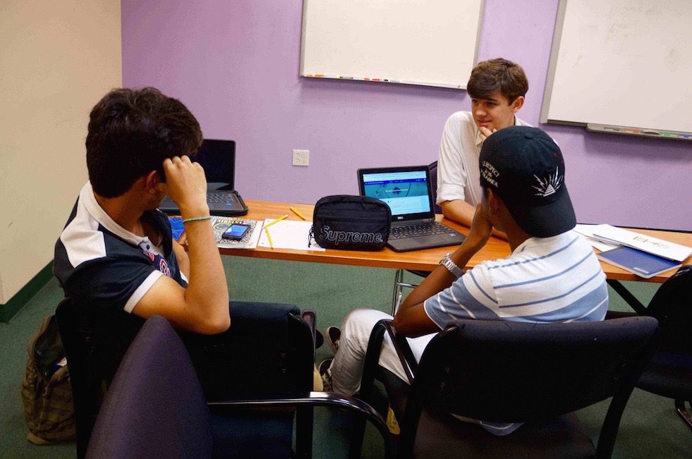Learning Works Charter School tutor helping students; a big part of why we chose this organization as a part of our corporate social responsibility initiative.